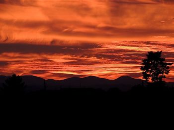 Silhouette of mountain against dramatic sky