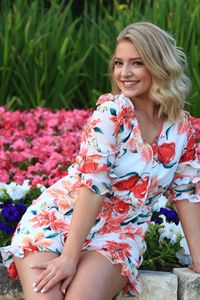 Portrait of smiling woman sitting in park