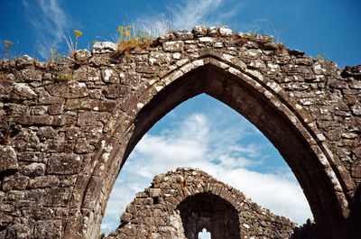 Low angle view of old ruins against sky