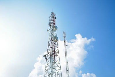 Low angle view of communications tower against blue sky