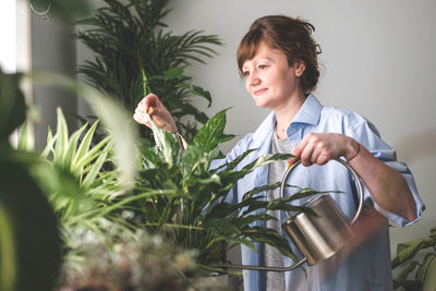 Side view of young woman holding bouquet