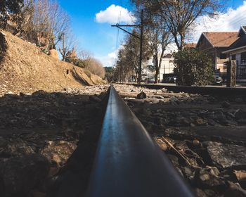 Surface level of railroad tracks against sky