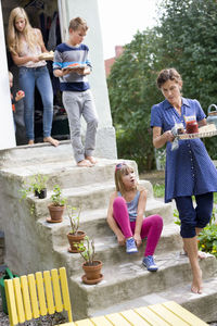 Family preparing lunch in back yard