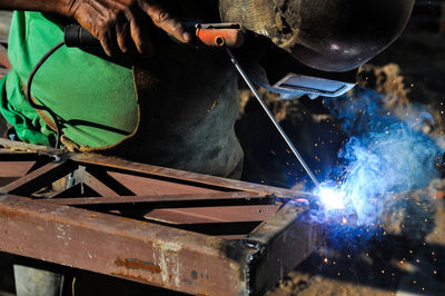 Welder welding in workshop