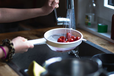 Midsection of man preparing food in kitchen