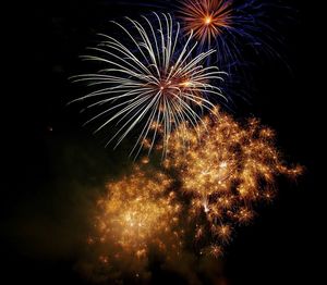 Low angle view of firework display at night