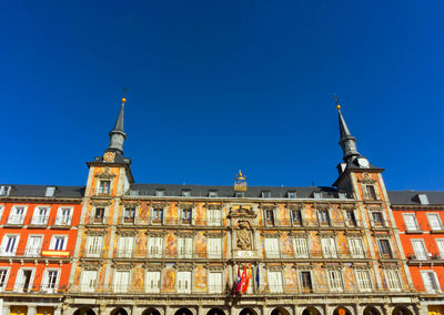 Low angle view of church against clear blue sky during sunny day