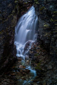 Waterfall from a mountain cleft in rondane, norway