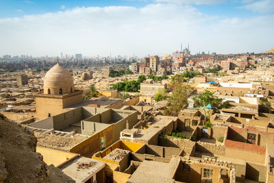 High angle view of buildings in town against sky