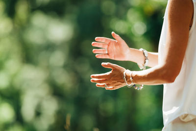 Woman practicing tai chi chuan outdoors. close up on hand position