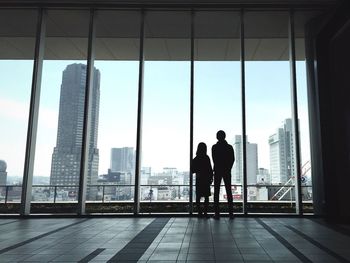 Woman standing in front of built structure