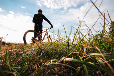 Man riding bicycle on field