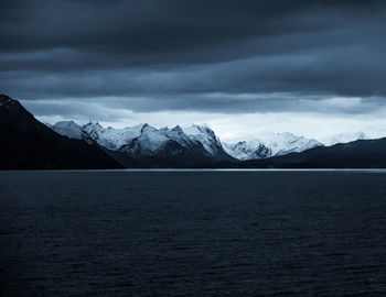 Scenic view of lake and mountains against sky