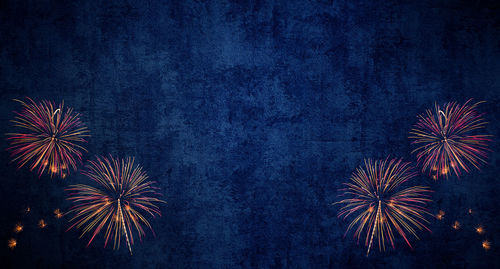 Low angle view of firework display in sky at night