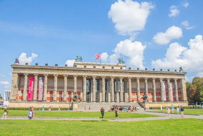 Group of people in front of built structure against sky