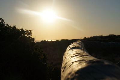 Scenic view of field against sky at sunset