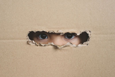 Close-up portrait of a serious young man with hole