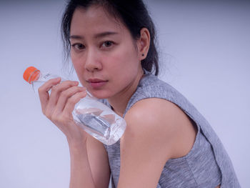 Portrait of woman drinking water from glass