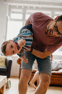 Father playing with son at home