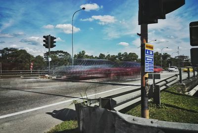 Road sign against sky in city