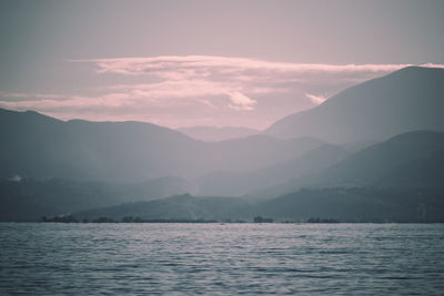 Scenic view of sea and mountains against sky during sunset