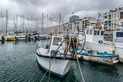 Fishing boats and sailboats docked in harbour along the coast of toulon, france. wide angle view.