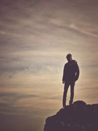 Silhouette man standing against sky during sunset