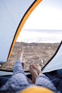 Low section of person relaxing on land