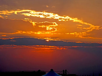 A red and golden burning sunset with clouds.