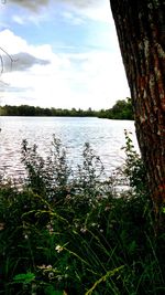 Scenic view of lake against cloudy sky