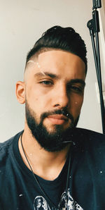 Portrait of young man against wall