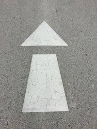 High angle view of arrow symbol on road