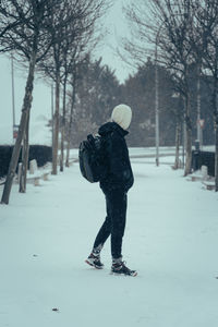 Rear view of man on snow covered field