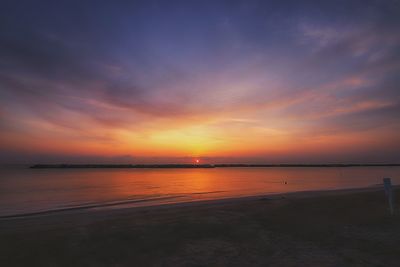 Scenic view of sea against romantic sky at sunset