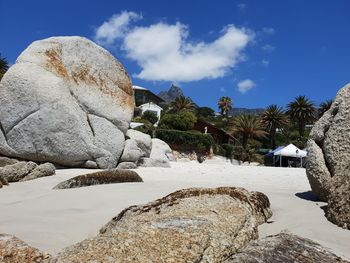 Rock formations by trees against sky