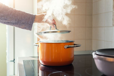 Cropped hand of person preparing food