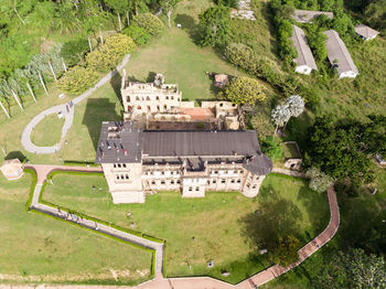 High angle view of houses and trees on field