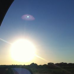 Scenic view of landscape against clear sky during sunset