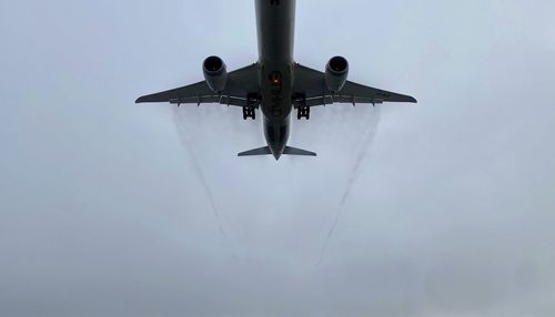 Low angle view of airplane against sky