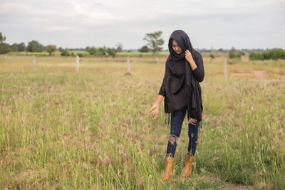 Full length of woman standing on field