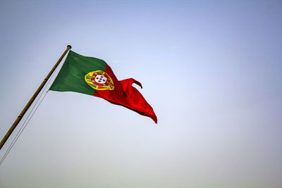 Low angle view of flag against clear sky