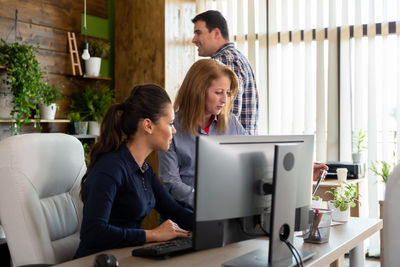 Side view of young woman working at home