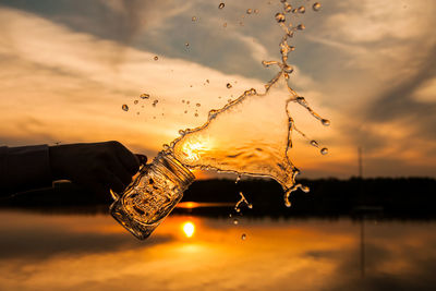 Close-up of water against orange sky
