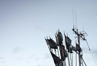 Low angle view of communications tower against sky