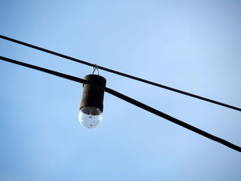 Low angle view of lamp post against blue sky