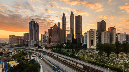 Panoramic view of city buildings against sky during sunset