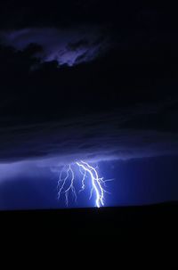 Low angle view of lightning in sky at night