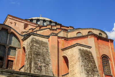 Low angle view of mosque against clear blue sky