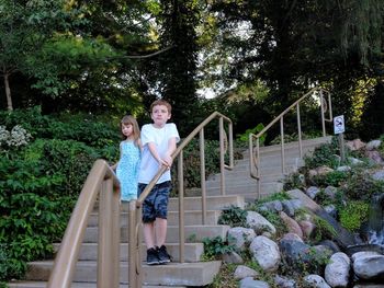 Rear view of couple walking on staircase