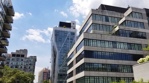 Exterior of modern buildings in city against sky